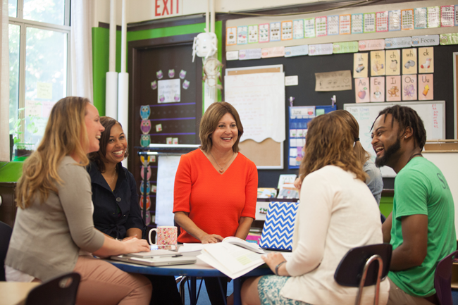 Teachers talking to a Coach.